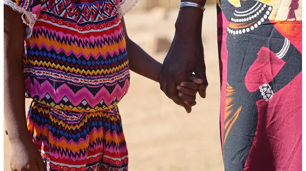 Empowering Women #1 - Synoetforgood A child holds her grandmother’s hand before the trial of her rapist at the Ambovombe Court in Madagascar.